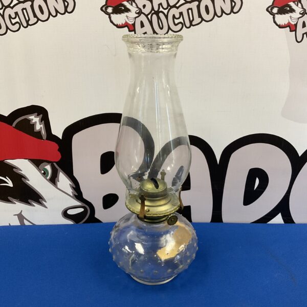 Vintage farmhouse oil lamp with textured glass.