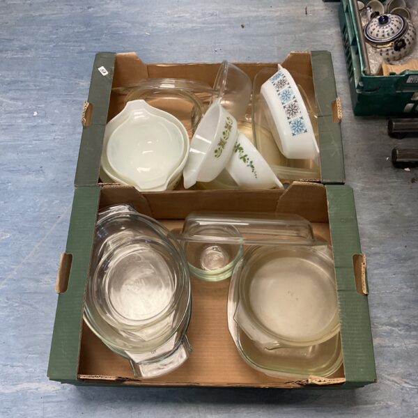 Vintage Fire King dishes in a green crate, retro kitchenware.