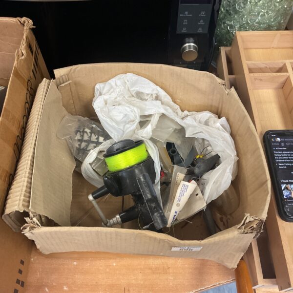 Vintage fishing tackle lot with reel and line.