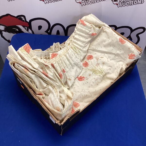 Vintage floral curtains with a cream background and patterned design.