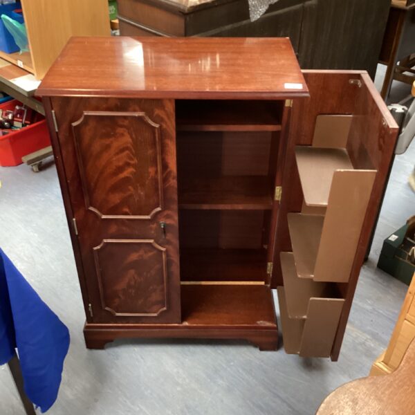 Vintage mahogany folding bookcase with doors open.