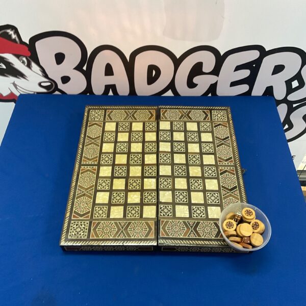 Vintage folding game board with inlaid design and wooden game pieces.