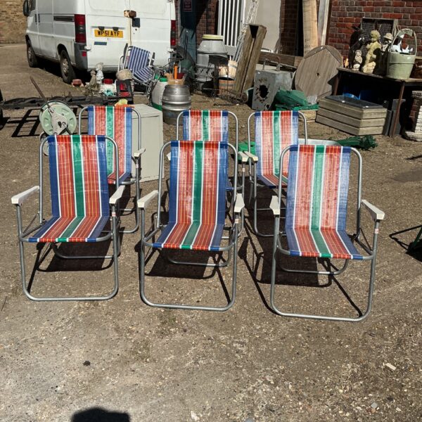 Six vintage folding garden chairs with colourful striped seats.