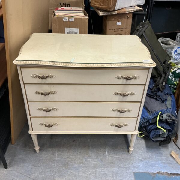 Vintage four-drawer cabinet with painted finish and decorative pulls.