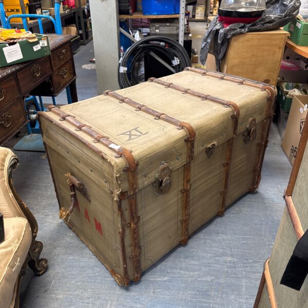 Large vintage French steamer trunk with wood banding.