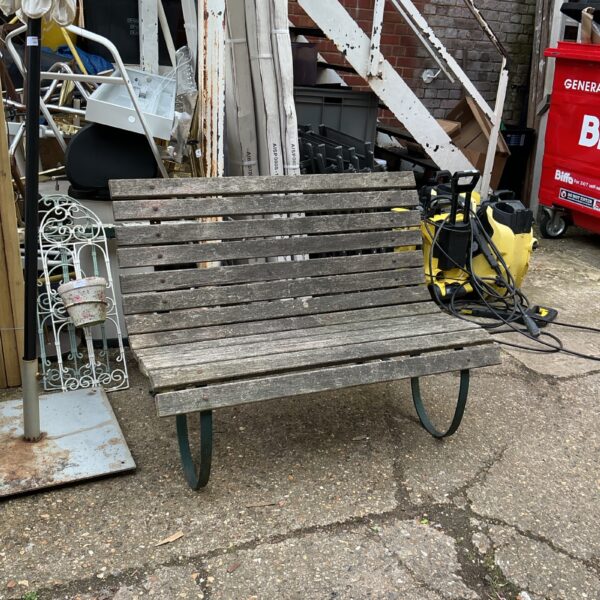 Rustic vintage garden bench with slatted seat and back.
