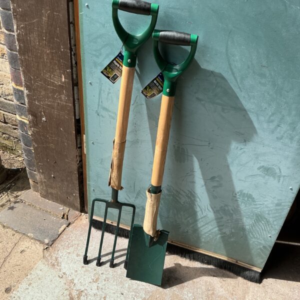 Vintage garden fork and spade set with wooden handles.