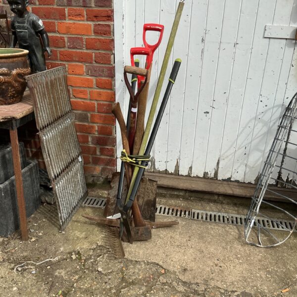 Vintage garden tool bundle with spade, fork, and hand tool.