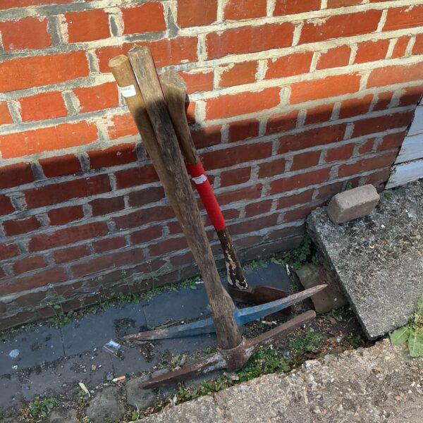 Vintage garden tools lot including picks and axe.
