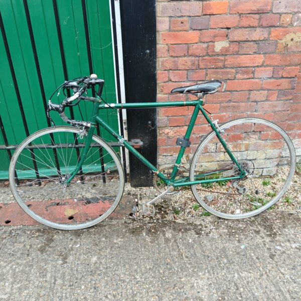 Side view of a vintage gents racer bike in need of restoration.