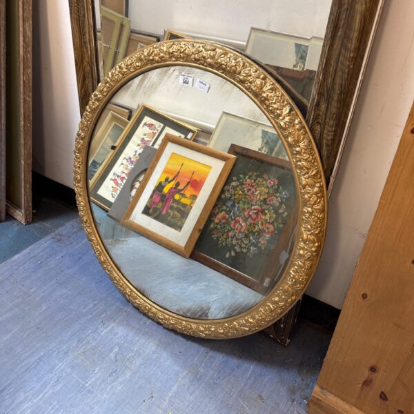 Vintage gilt framed circular mirror for wall decoration.