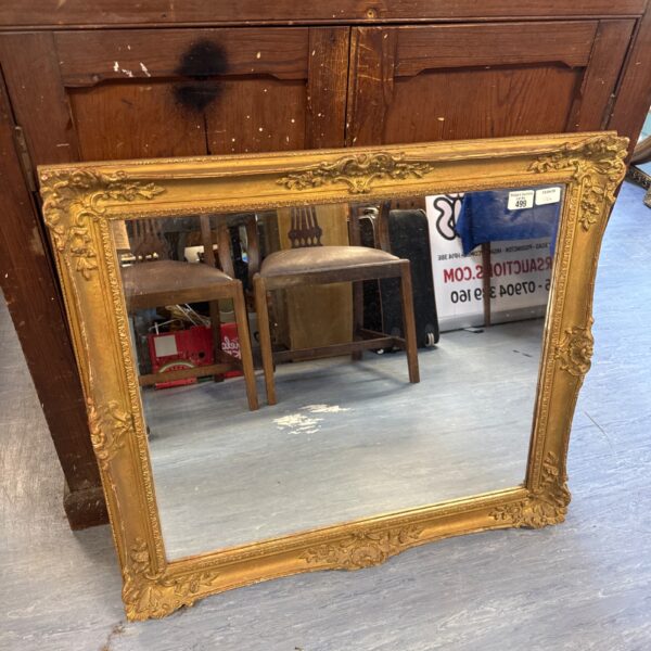 Ornate vintage gilt framed mirror for wall decoration.