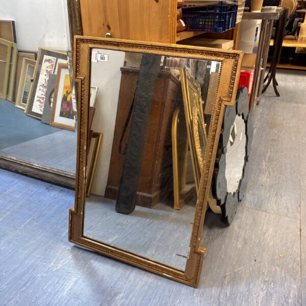 Ornate vintage gilt framed mirror for wall decoration.