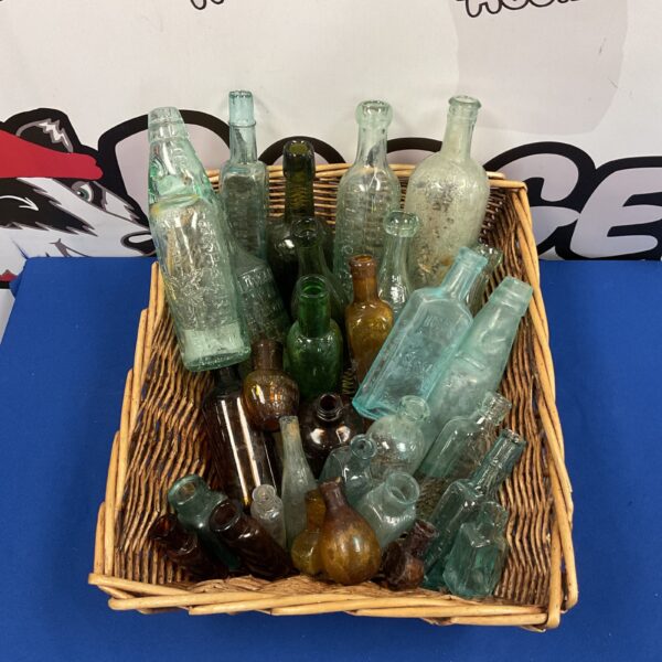 Vintage glass bottle collection with Bovril and Hoods bottles.
