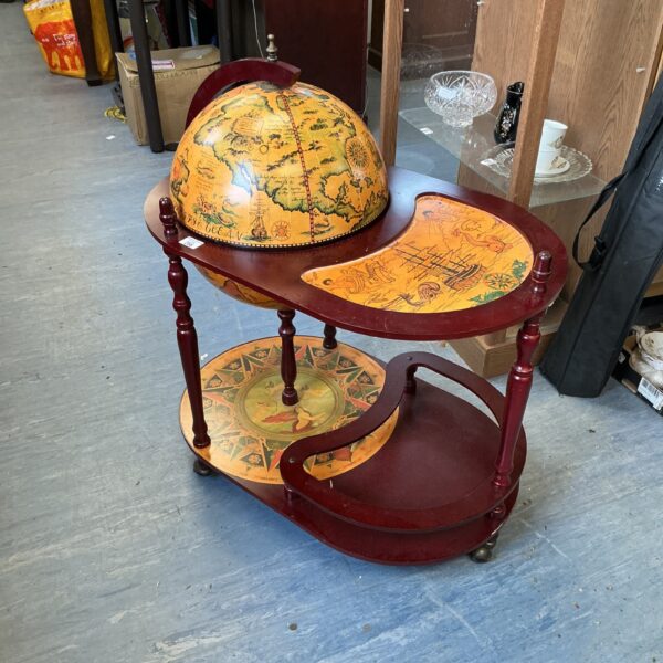 Vintage globe bar cabinet with wooden legs and detailed cartography.