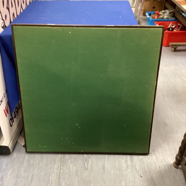 Vintage green folding card table with felt surface.