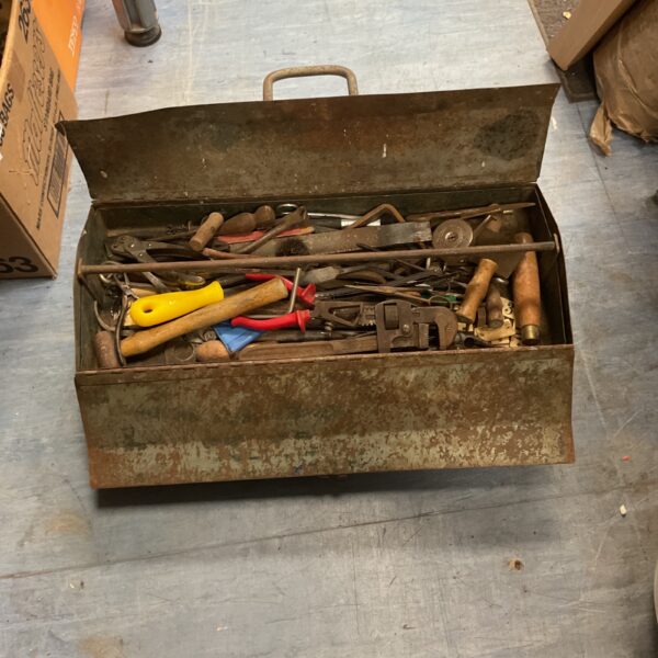 Vintage green metal toolbox with tools inside, classic workshop storage.