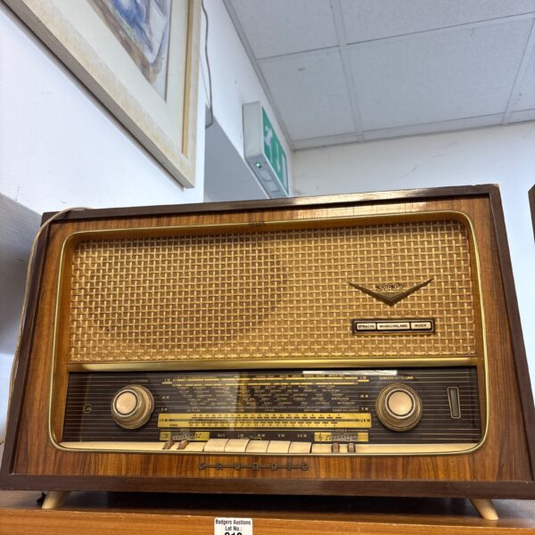 Vintage Grundig 1950s tabletop radio in wooden cabinet.