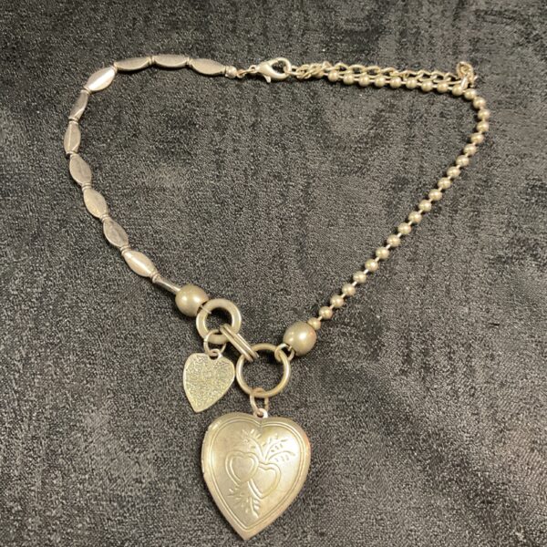 Vintage gold tone heart locket necklace with double pendant.