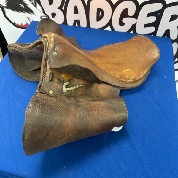 Vintage leather horse saddle, antique equestrian tack.