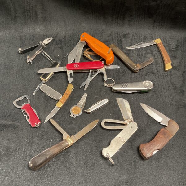 Vintage knife collection featuring Swiss Army and Ibberson folding knives.