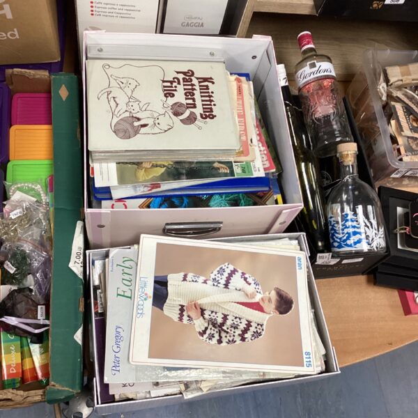 Two boxes of vintage knitting and sewing pattern files for crafting.