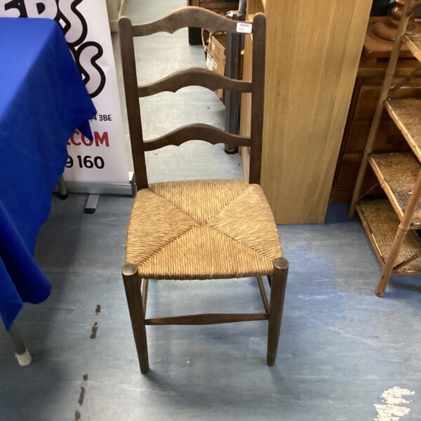 Vintage ladder back chair with woven seat, country style.