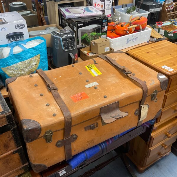 Large vintage leather travel case with travel labels.