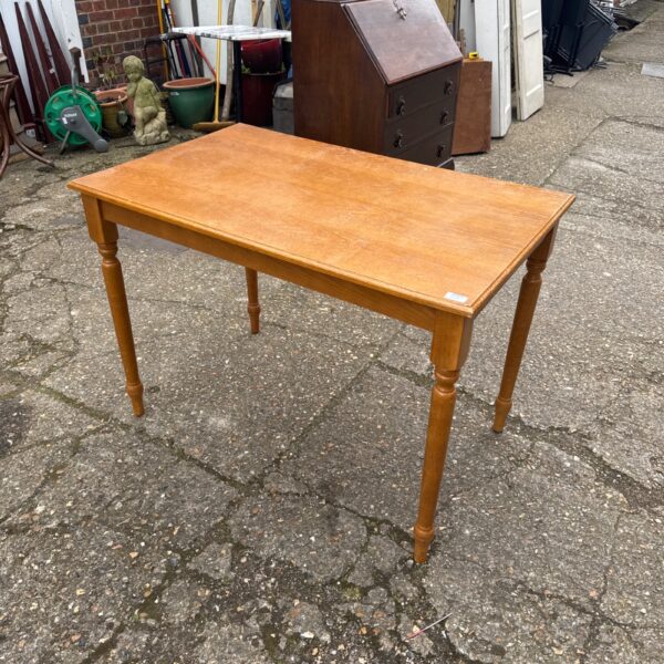 Vintage light oak table with a classic farmhouse style.