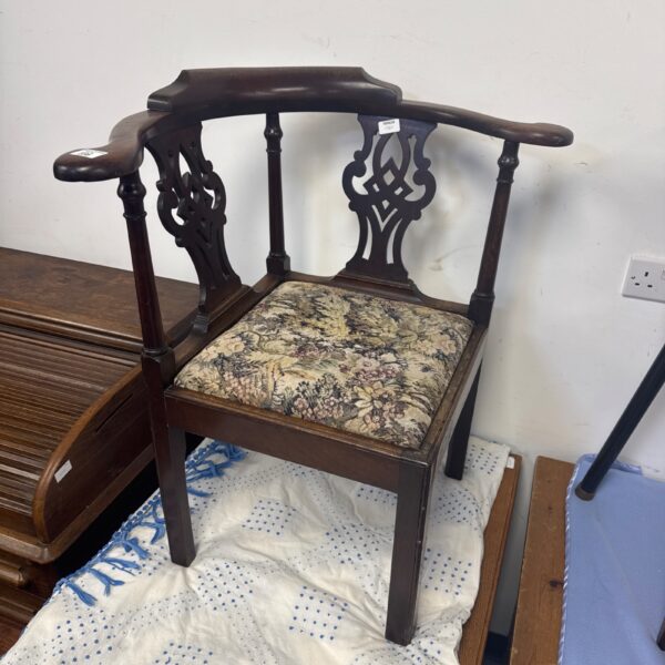 Vintage mahogany corner chair with floral upholstery.