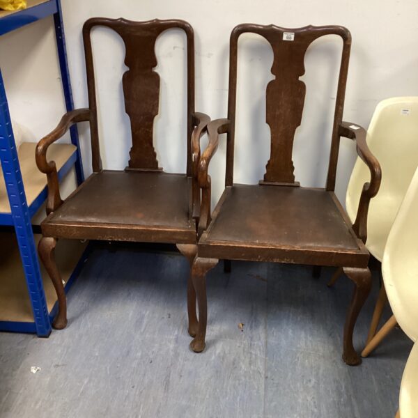 Pair of vintage mahogany dining carvers with leather seats.