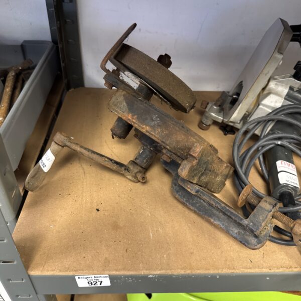 Vintage manual bench grinder with cast iron frame.