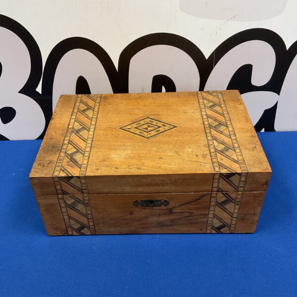 Vintage marquetry jewellery box with inlaid wood detail.