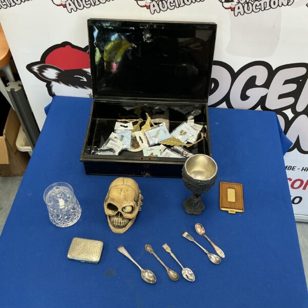 Vintage metal box with assorted collectibles and a crystal jar.