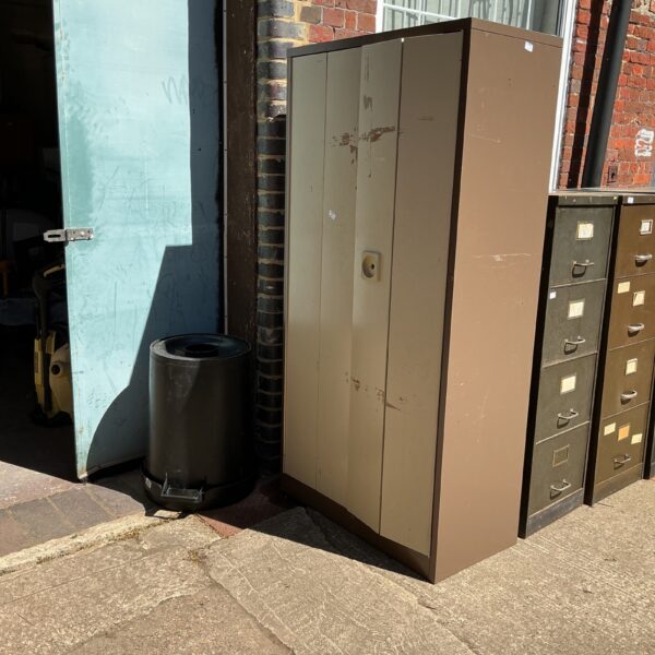 Vintage metal filing cabinet with drawers, ideal for office storage.