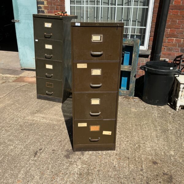 Vintage metal filing cabinet with four drawers, ideal for office storage.