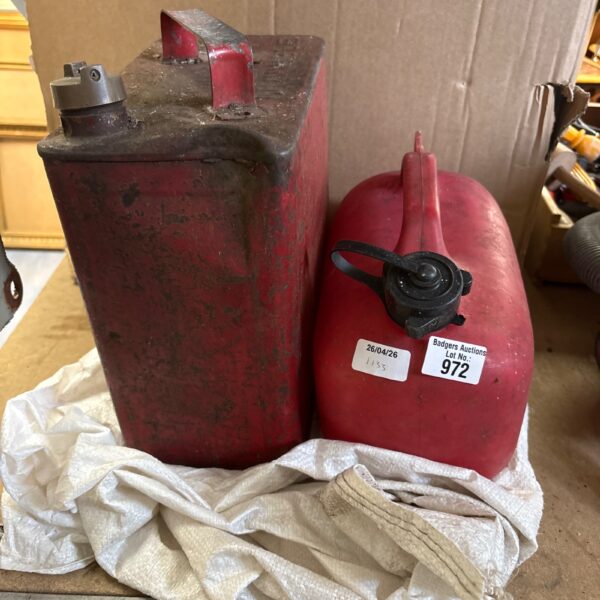 Vintage metal petrol can for fuel storage, showing signs of age.