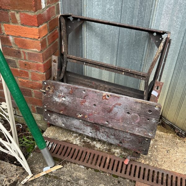 Vintage metal workbench frame with rust and patina.