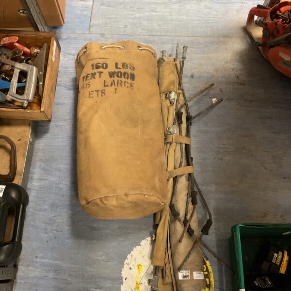 Vintage military canvas tent bag with markings for tent poles.