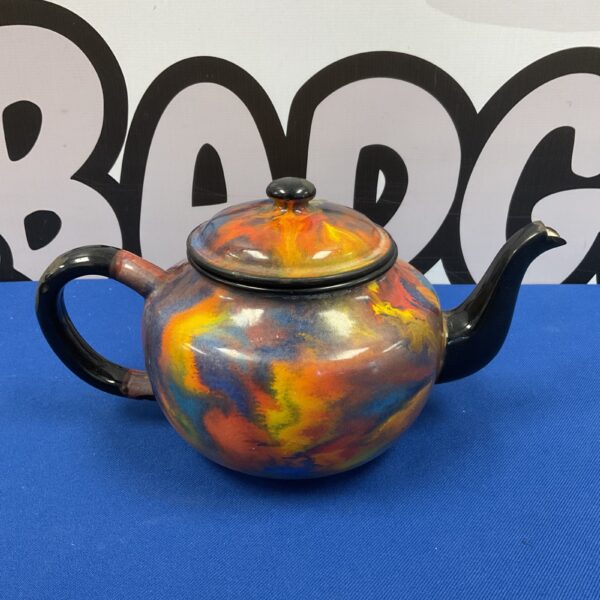 Vintage multicoloured enamel teapot, a striking kitchen collectible.