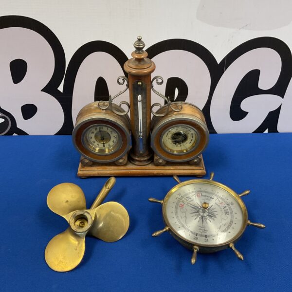 Vintage brass nautical desk set with clock, thermometer, and barometer.
