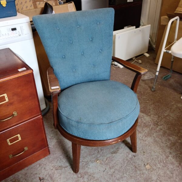 Blue vintage nursing chair with rounded seat and wooden frame.