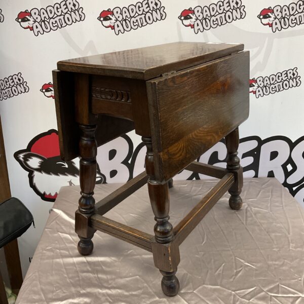 Vintage oak drop leaf table with turned legs.