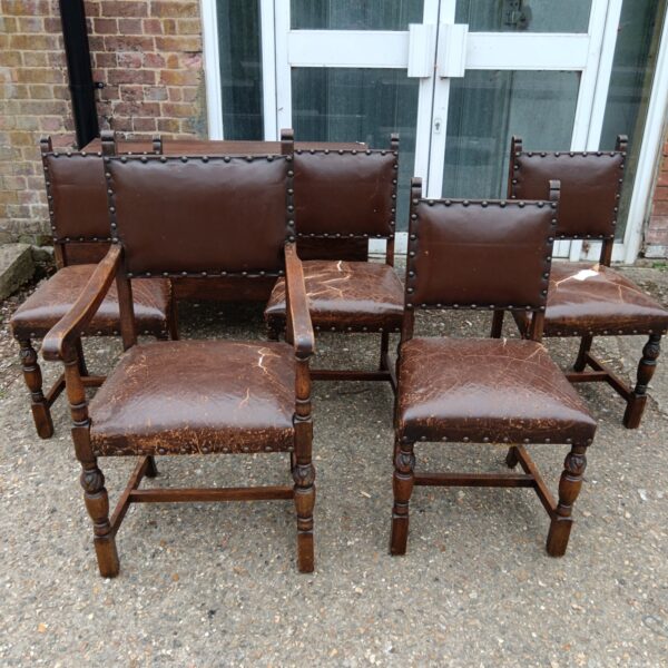 Set of five vintage oak pub chairs with dark upholstery.