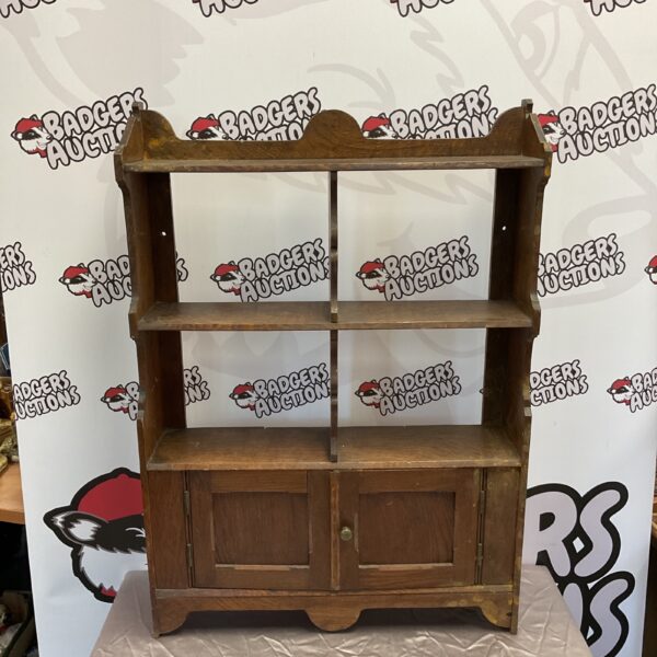 Small vintage oak shelving unit with cupboard and open shelves.