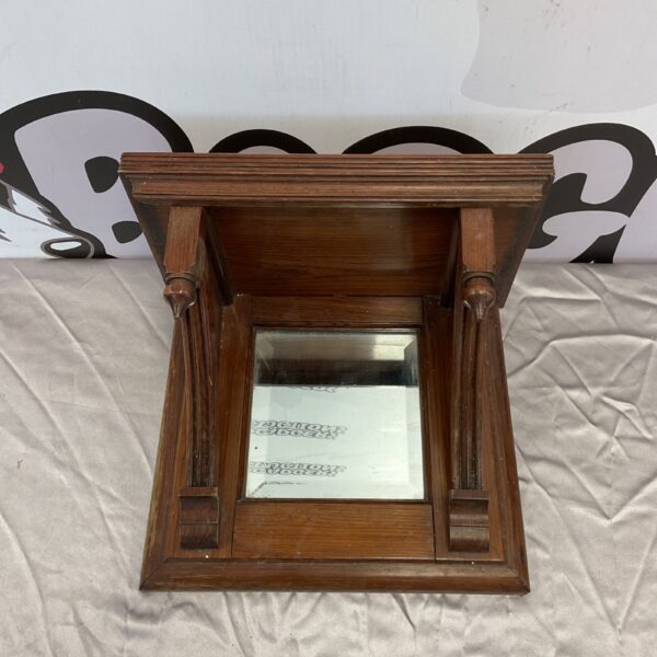 Vintage oak wall shelf with mirror and carved corbels.