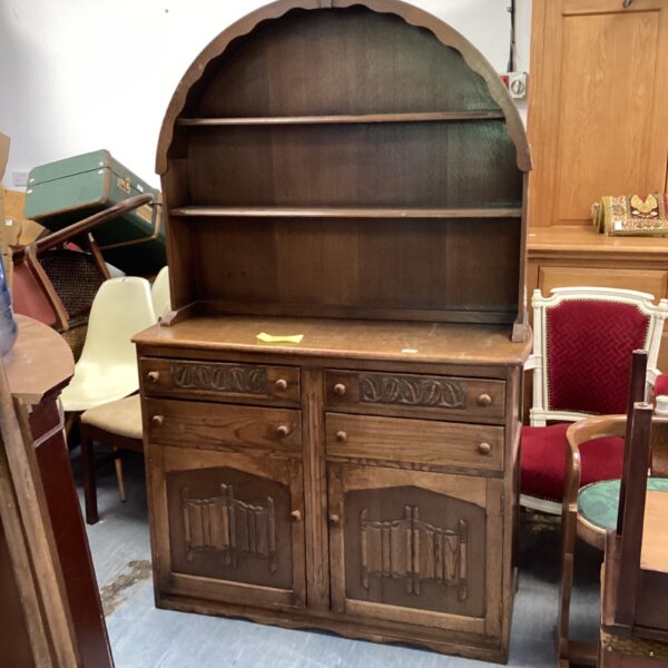Vintage oak Welsh dresser with drawers and cupboards for kitchen storage.