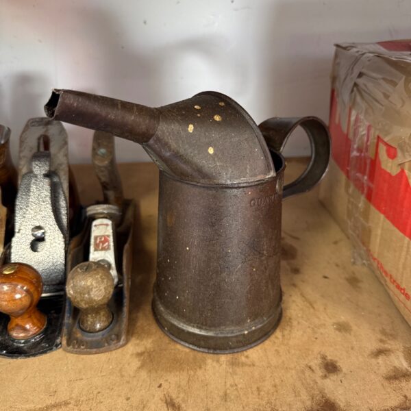 Vintage metal oil can with curved spout, ideal for collectors.