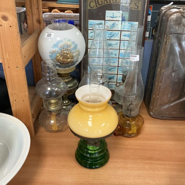 Vintage green glass oil lamp with clear shade.