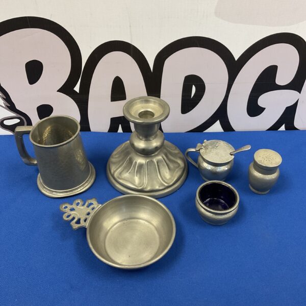 Vintage pewter collection featuring a quache cup and candlestick.